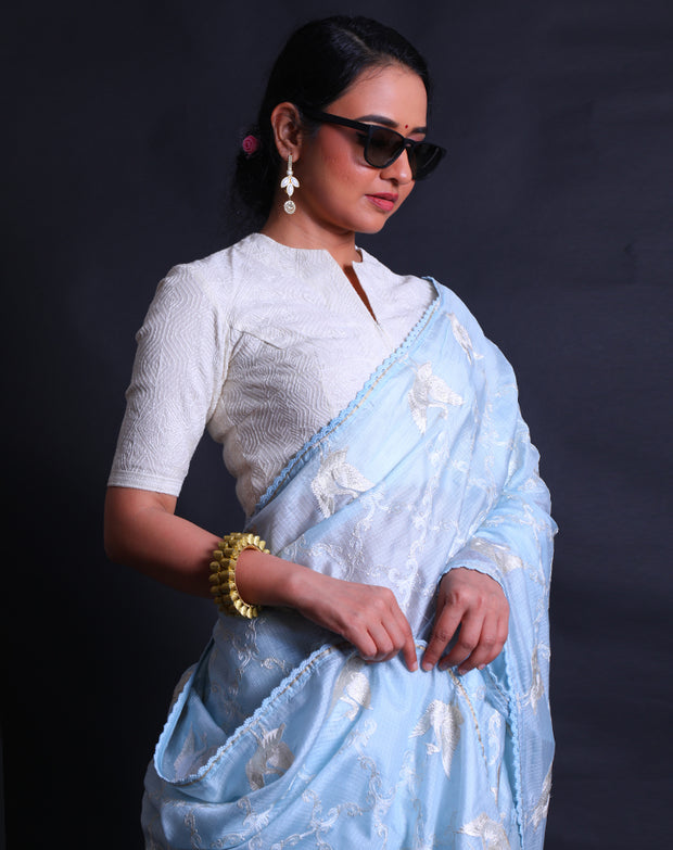 The light blue silk Kota saree adorned with thread and silver zari embroidery all over the drape sounds absolutely stunning,- EMB03354