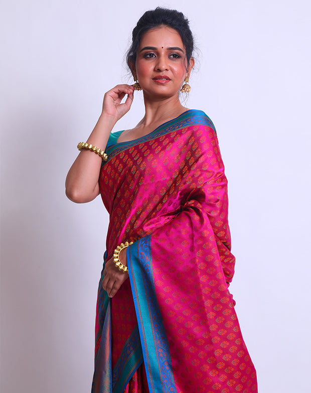 The combination of Pink Banarsi silk with a contrast blue border and pallu - BSK09553