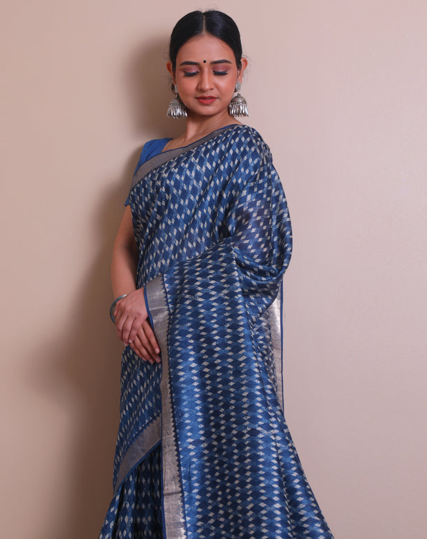 The indigo Tussar printed saree with a zari border and pallu sounds like a contemporary take on traditional elegance. - PTS05288