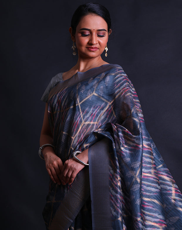 The dark grey blended saree with print all over and zari lines woven throughout the drape,- BLN01275
