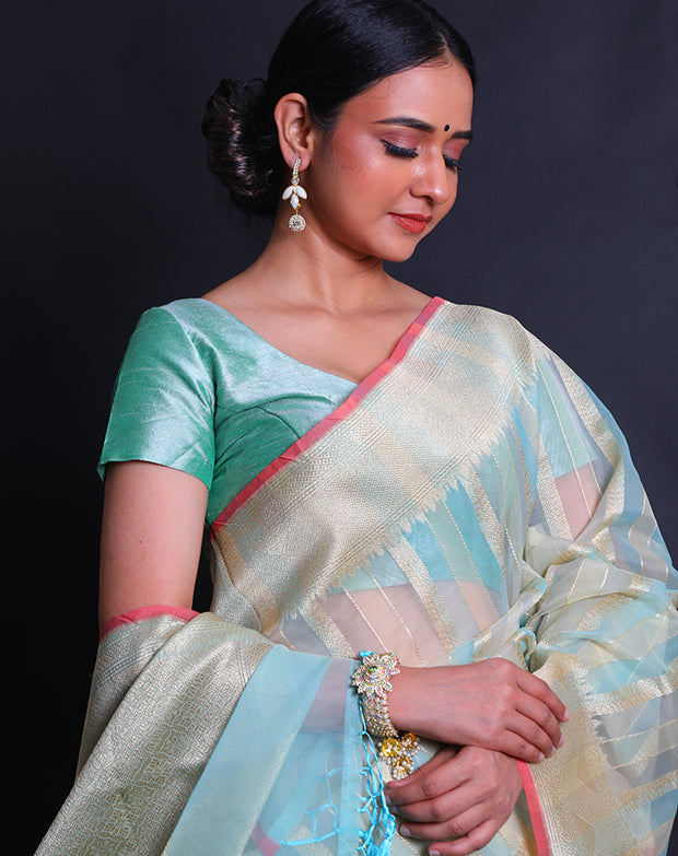A fancy cotton light blue saree features zari lines woven all over the drape, - FCT011113