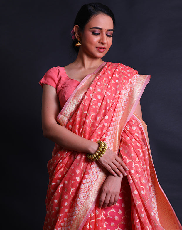 The peach kora cotton saree with zari and thread woven in different designs.- BSK010448