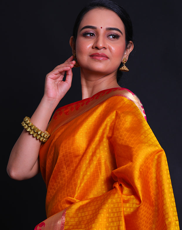 The mustard Kanjivaram soft silk saree with self buttis all over the drape sounds elegant and classic.- KSL02999