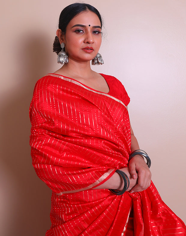 The red Banarasi handloom silk saree with small zari border and tiny zari motifs in line designs all over the drape, - BSK010760