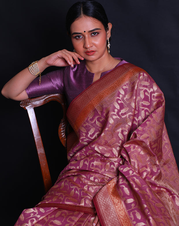 The pink Banarasi saree you're describing is adorned with antique zari woven throughout the drape,- BSK010674