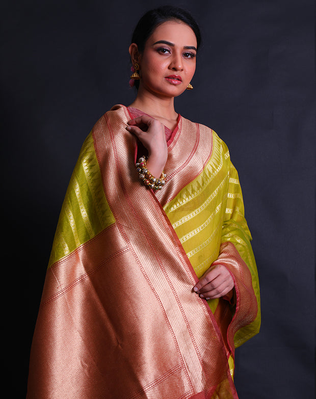 The green Banarasi cotton saree with zari horizontal lines all over the drape sounds elegant and refined.- BSK010641