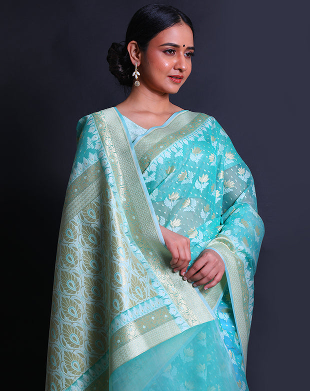 The sea green kora cotton saree with lotus and leaf designs woven in thread and zari sounds exquisite, - BSK010448