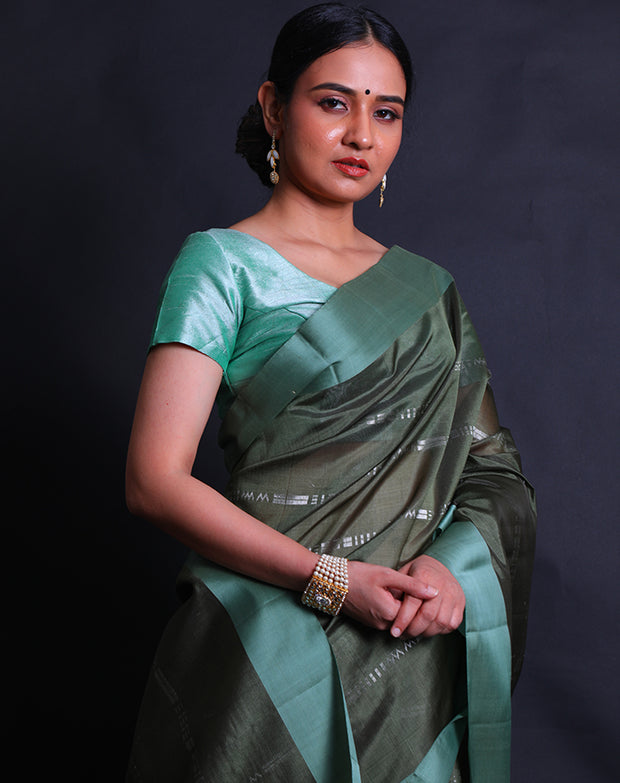 The dark green South silk saree with silver zari woven in geometric lines sounds striking,- KSL03119