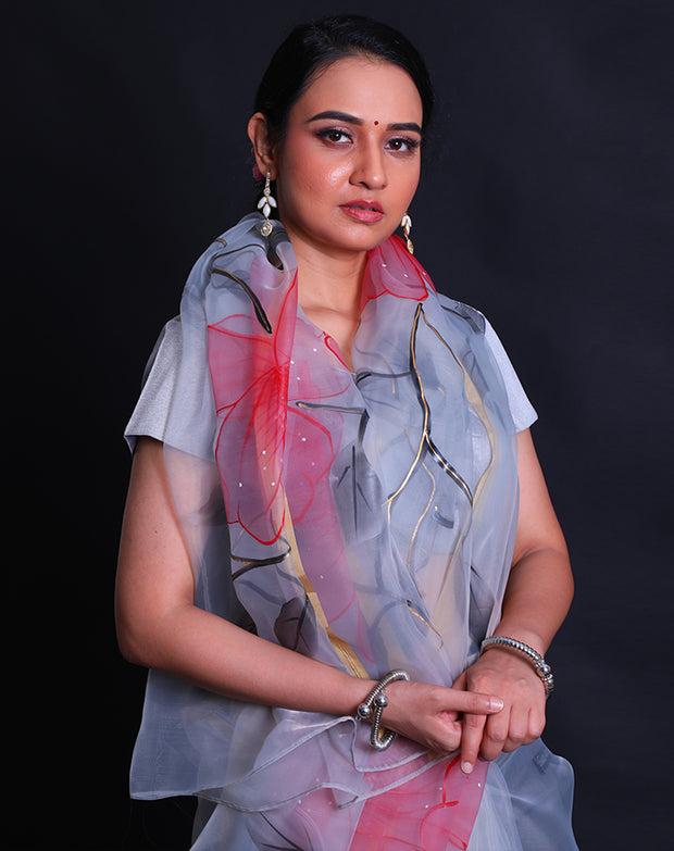 The grey blended organza saree with handprint in a colorful way, along with gold lines hand-printed in a modern attire,- BLN01279