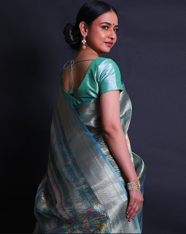 A multi-blended tissue saree features a zari border that adds a touch of sophistication to the ensemble. - FCT011107