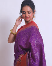 The purple soft Tussar Handloom saree with a red contrast and zari woven border and pallu sounds enchanting - BSK010663
