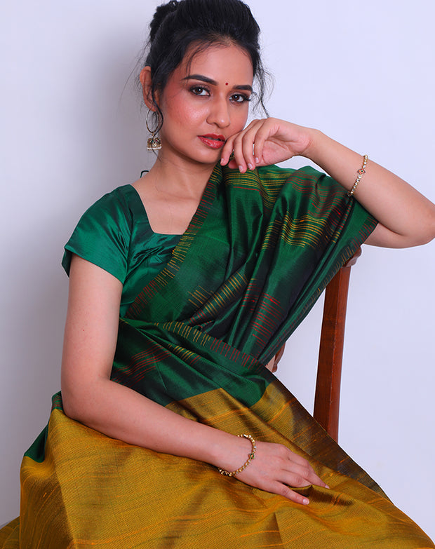 A Bottle Green South Soft Silk saree with a combination of red and yellow lines woven as a design on the border and all over the drape sounds captivating - KSL03091