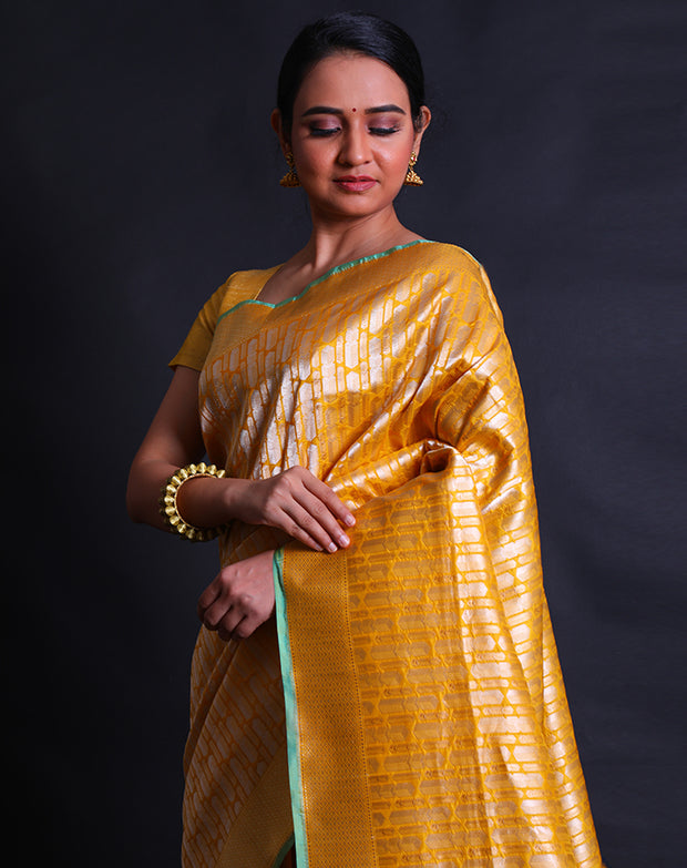 The mustard Banarasi silk saree with gold and silver buttis in a geometrical design,- BSK010514