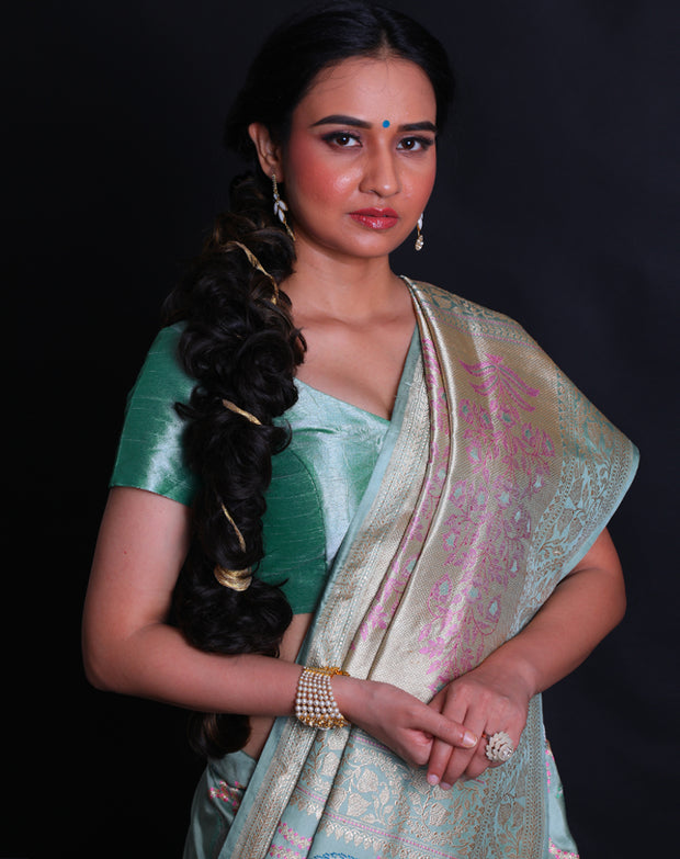 The sea green Banarsi silk saree exudes grace with its vibrant modern design intricately woven in thread and zari,- BSK010513
