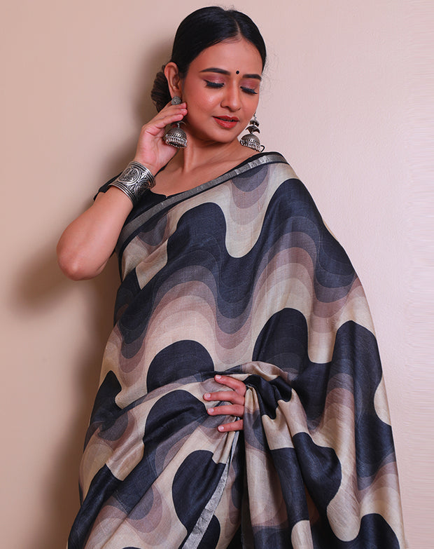 The black pure Tussar saree with modern print all over the drape, accented by a silver zari border - PTS05297