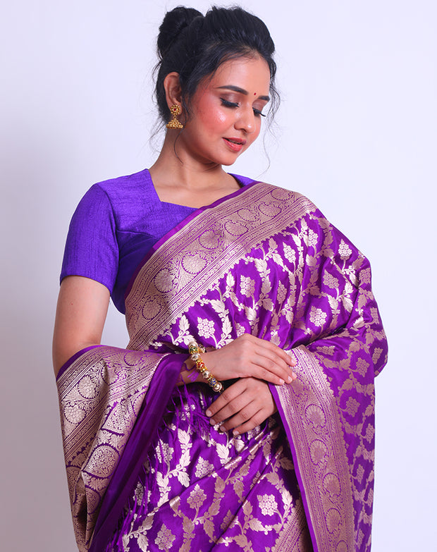 The Purple Banarsi Handloom Silk saree with a zari border and pallu woven with purple tassels must be absolutely enchanting - BSK010767