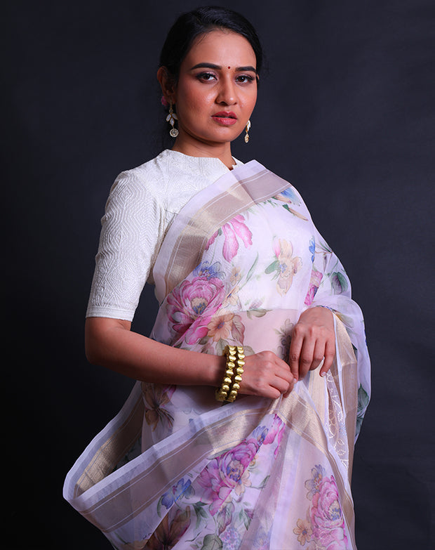 The pink organza saree with digital print in flower design all over the drape offers a modern and vibrant aesthetic.- BLN01555