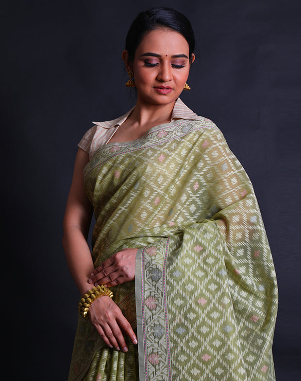 The light green cotton saree with different colored threads woven into designs as buttis.- FCT011114